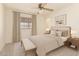 Bright bedroom featuring a window, a ceiling fan, and neutral tones for a peaceful and inviting atmosphere at 6521 W Flower St, Phoenix, AZ 85033