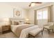 Inviting bedroom with soft lighting, a ceiling fan, and neutral tones, creating a warm and comfortable atmosphere at 6521 W Flower St, Phoenix, AZ 85033