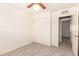 Neutral bedroom with a ceiling fan, closet and carpeted floors at 6521 W Flower St, Phoenix, AZ 85033