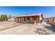 This single-story home has a spacious front yard and covered parking next to the covered entry at 6521 W Flower St, Phoenix, AZ 85033