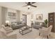 Bright living room with neutral tones, stylish furniture, ceiling fan and a large window for ample natural light at 6521 W Flower St, Phoenix, AZ 85033