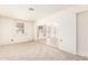 A large living room offers carpet flooring and multiple windows at 6521 W Flower St, Phoenix, AZ 85033