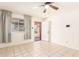 A bright living room showcases neutral tile flooring and a large window at 6521 W Flower St, Phoenix, AZ 85033