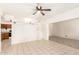 A spacious living room offers neutral tile flooring and a ceiling fan at 6521 W Flower St, Phoenix, AZ 85033