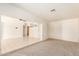 A spacious living room offers carpet and tile flooring and open floor plan at 6521 W Flower St, Phoenix, AZ 85033