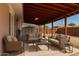 Relaxing covered patio featuring comfortable seating and a view of the backyard at 6521 W Flower St, Phoenix, AZ 85033