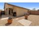 A gravel-covered backyard with a covered patio and barbecue for outdoor entertaining at 6610 E University Dr # 127, Mesa, AZ 85205