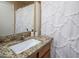 Clean and bright bathroom features a granite countertop and decorative shower curtain at 6610 E University Dr # 127, Mesa, AZ 85205