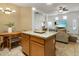 Open kitchen area view, granite island top with chairs. View extends to the living room at 6610 E University Dr # 127, Mesa, AZ 85205