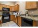 Functional kitchen featuring stainless steel appliances, granite countertops, and wooden cabinetry at 6610 E University Dr # 127, Mesa, AZ 85205