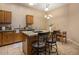 Eat-in kitchen with granite countertops, an island with barstool seating and bright lighting at 6610 E University Dr # 127, Mesa, AZ 85205
