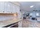 Beautiful kitchen flowing into the living area, featuring granite countertops and tile flooring at 6721 E Mcdowell Rd # B309, Scottsdale, AZ 85257