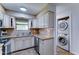 Bright kitchen with stainless steel appliances, granite countertops, and included washer/dryer at 6721 E Mcdowell Rd # B309, Scottsdale, AZ 85257