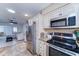 Spacious kitchen and living area featuring granite counters, stainless appliances, and ample cabinetry at 6721 E Mcdowell Rd # B309, Scottsdale, AZ 85257