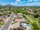 Aerial view of residential neighborhood featuring mature landscaping and community green spaces at 6967 W Irma Ln, Glendale, AZ 85308