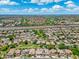 Expansive aerial view of the neighborhood, showcasing the community layout, nearby golf course, and accessible highways at 6967 W Irma Ln, Glendale, AZ 85308