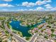 Beautiful aerial showcasing a lake, lush landscaping, and well-maintained neighborhood streets at 6967 W Irma Ln, Glendale, AZ 85308