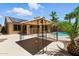 Outdoor gazebo offers a shaded retreat, overlooking a sparkling pool and beautifully landscaped backyard, ideal for relaxation at 6967 W Irma Ln, Glendale, AZ 85308