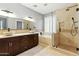 Updated bathroom with double sinks, walk-in shower, and separate soaking tub at 6967 W Irma Ln, Glendale, AZ 85308