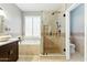 The bathroom features a glass-door shower and separate tub at 6967 W Irma Ln, Glendale, AZ 85308