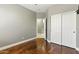 This bedroom has wood floors, a ceiling fan, and a large closet at 6967 W Irma Ln, Glendale, AZ 85308
