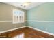 Light-filled bedroom featuring hardwood floors and neutral paint color with a window at 6967 W Irma Ln, Glendale, AZ 85308