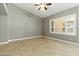 Bright, airy bedroom with a ceiling fan, plantation shutters, and a tile floor at 6967 W Irma Ln, Glendale, AZ 85308