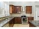Gourmet kitchen with stainless steel appliances and custom cabinets at 6967 W Irma Ln, Glendale, AZ 85308