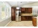 Bright kitchen showcases custom cabinetry, stainless steel appliances, and plantation shutters at 6967 W Irma Ln, Glendale, AZ 85308