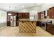 Modern kitchen features wood cabinetry, granite countertops, stainless steel appliances, and island at 6967 W Irma Ln, Glendale, AZ 85308