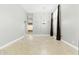 Open-concept living room with chandelier lighting, neutral walls, and tiled floor at 6967 W Irma Ln, Glendale, AZ 85308