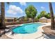 Backyard pool surrounded by lush landscaping and secure fencing provides a private oasis for relaxation and recreation at 6967 W Irma Ln, Glendale, AZ 85308