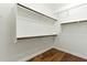 Spacious walk-in closet with custom shelving and wood floors at 6967 W Irma Ln, Glendale, AZ 85308