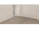 This is a bedroom with gray carpet and neutral walls, showing a doorway to another room at 716 S Lewis --, Mesa, AZ 85210