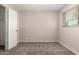 A comfortable bedroom with carpet, featuring an open closet door and natural light from the window at 716 S Lewis --, Mesa, AZ 85210
