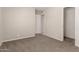 A calm bedroom with neutral carpet, offering a peaceful retreat with a glimpse of an open door at 716 S Lewis --, Mesa, AZ 85210