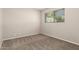 A bright bedroom with a window, neutral carpet, and paint, offering a simple, clean aesthetic at 716 S Lewis --, Mesa, AZ 85210