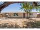 Charming single-story home with brick accents and a well-maintained front yard at 716 S Lewis --, Mesa, AZ 85210