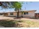 Single-story home featuring mature trees and a well-maintained front yard at 716 S Lewis --, Mesa, AZ 85210
