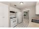 A kitchen featuring a stove, refrigerator, overhead cabinets and a view into an adjacent room through the doorway at 716 S Lewis --, Mesa, AZ 85210