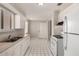 An efficient kitchen layout featuring white appliances, white cabinets and a double sink beneath the window at 716 S Lewis --, Mesa, AZ 85210