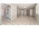 An open living space is shown with tile flooring and a kitchen adjacent to the living space at 716 S Lewis --, Mesa, AZ 85210