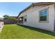 Well-maintained backyard featuring artificial grass, a low stone wall, and privacy fencing at 7423 S 28Th Pl, Phoenix, AZ 85042