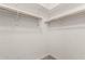 Spacious walk-in closet with built-in shelving and ample hanging space at 7423 S 28Th Pl, Phoenix, AZ 85042