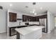 Modern kitchen with stainless steel appliances, dark wood cabinetry, and a large island at 7423 S 28Th Pl, Phoenix, AZ 85042