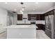 Stylish kitchen featuring dark wood cabinets, quartz countertops, and stainless steel appliances at 7423 S 28Th Pl, Phoenix, AZ 85042