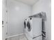 Bright laundry room with tile flooring and modern appliances at 7423 S 28Th Pl, Phoenix, AZ 85042