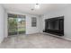 Bright room with neutral tile flooring, sliding glass doors, and built-in wall television at 7423 S 28Th Pl, Phoenix, AZ 85042