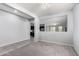 Open-concept living space with tile flooring leading to a view of the modern kitchen at 7423 S 28Th Pl, Phoenix, AZ 85042