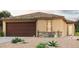 Charming single-story home with a tile roof, desert landscaping and an attached two-car garage at 7956 S Namaka Dr, Casa Grande, AZ 85193